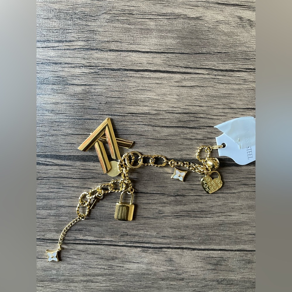 NWT: A gold plated stainless steel designer insp bracelet